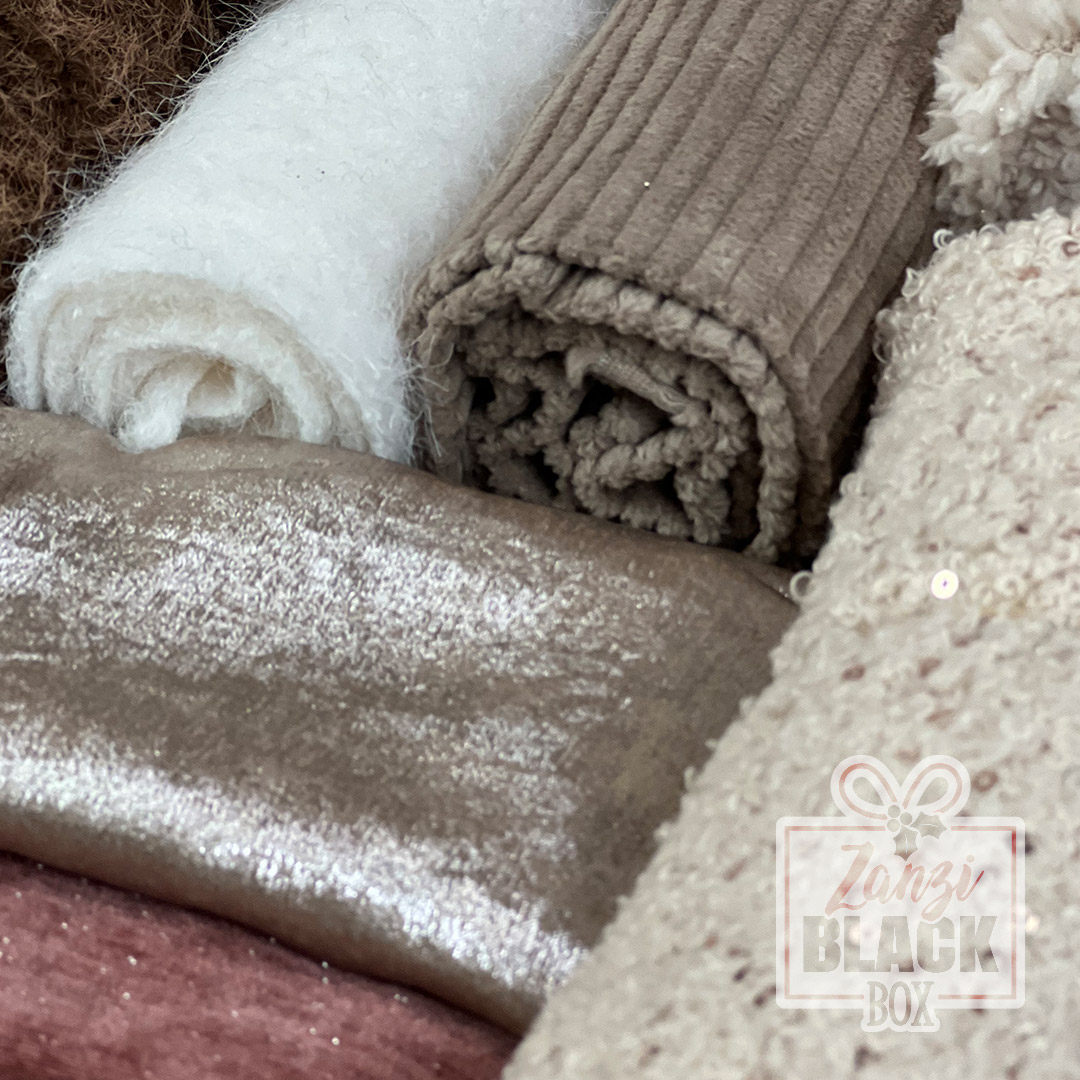 Rotoli di tessuti morbidi in tonalità neutre