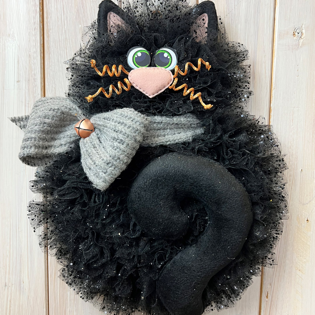 Gatto nero decorativo con sciarpa grigia e campanello