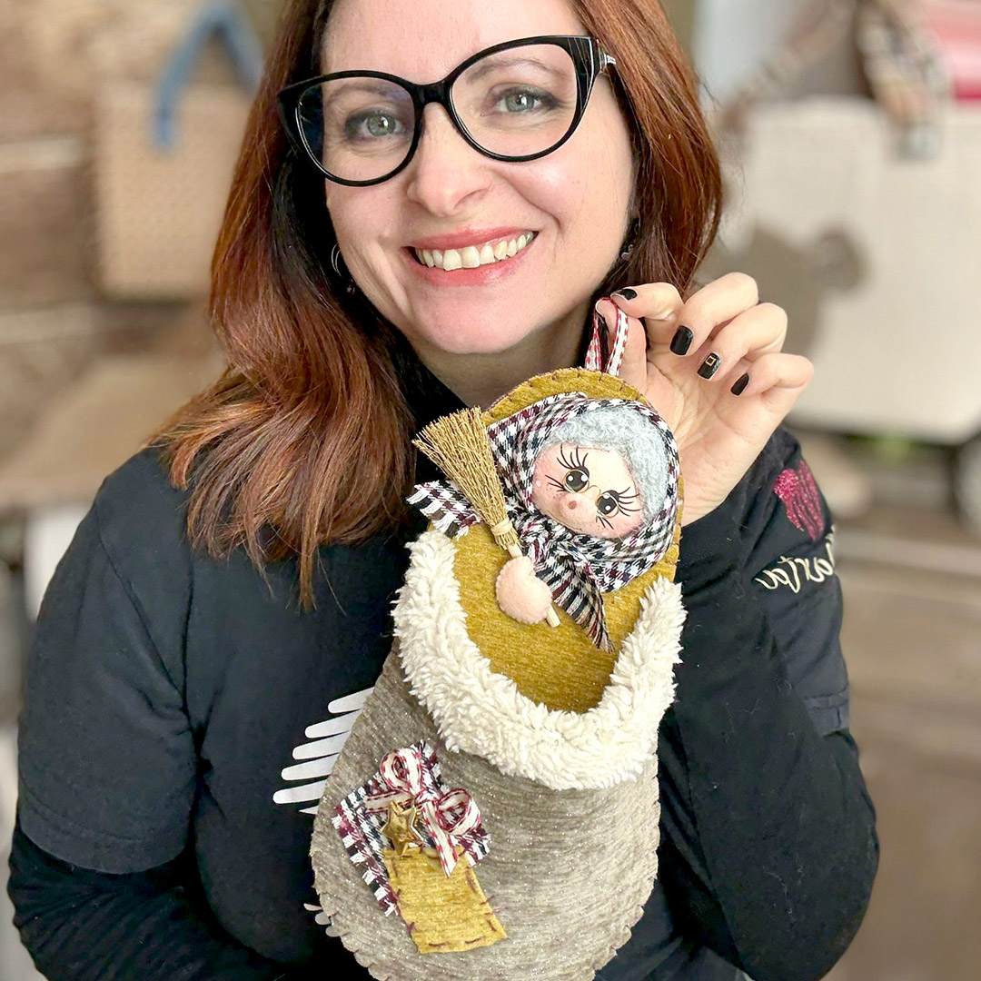 Donna mostra calza della Befana artigianale