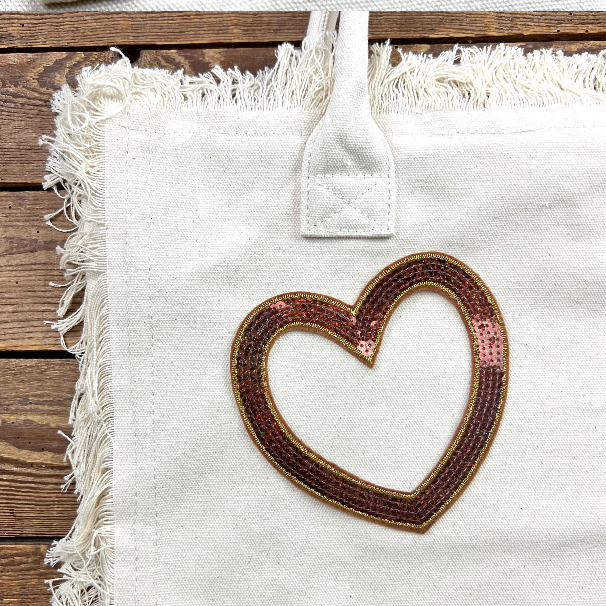 Borsa in tela con cuore di paillettes